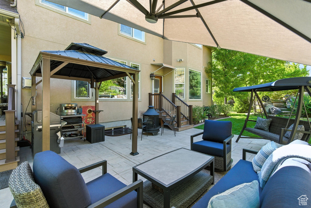View of patio featuring an outdoor living space, a gazebo, and grilling area