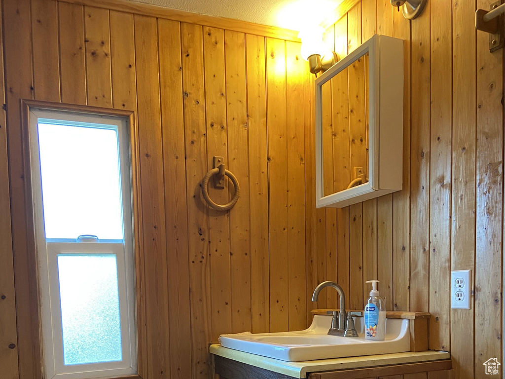 Bathroom featuring wood walls