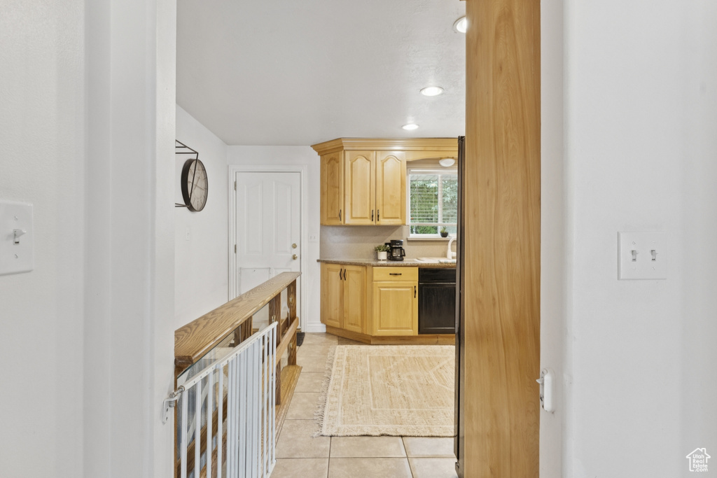 Kitchen featuring light brown cabinetry, light tile patterned floors, light countertops, and recessed lighting