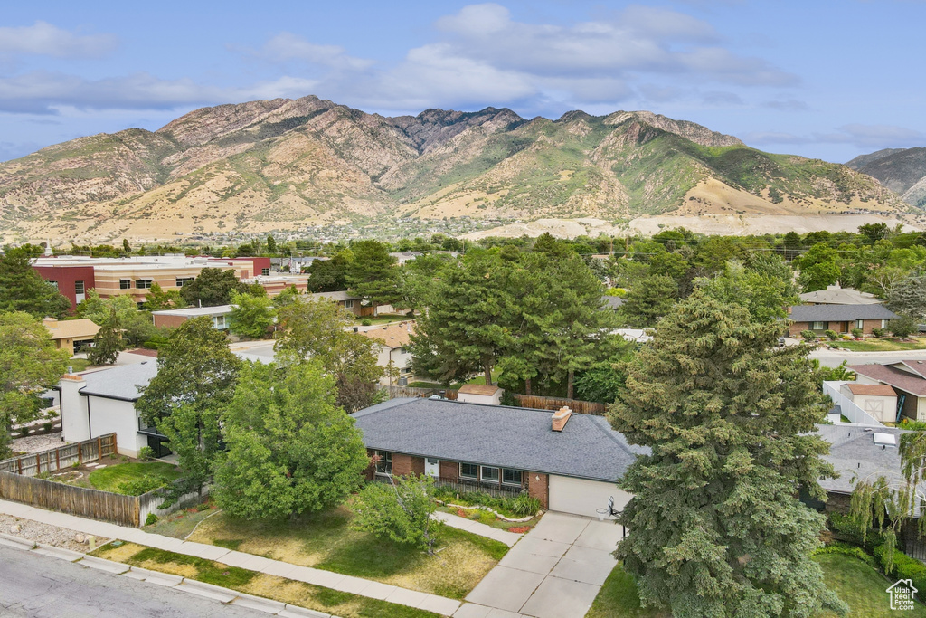 View of mountain backdrop featuring nearby suburban area