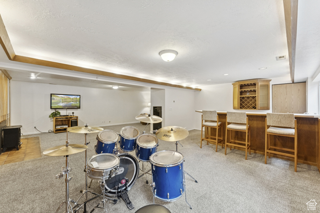 Playroom featuring a dry bar, a textured ceiling, light carpet, and recessed lighting