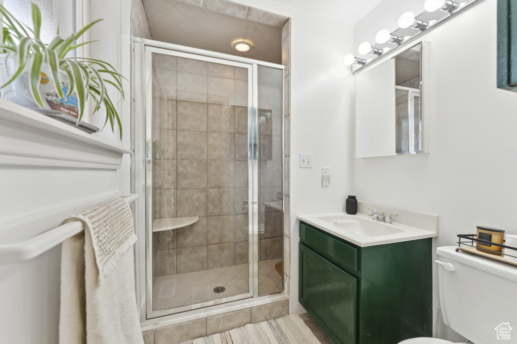 Bathroom featuring vanity and a stall shower