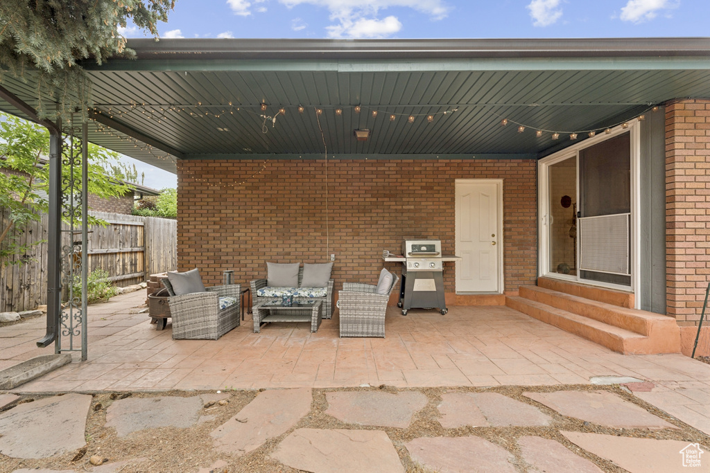 View of patio / terrace with entry steps, an outdoor living space, and a grill