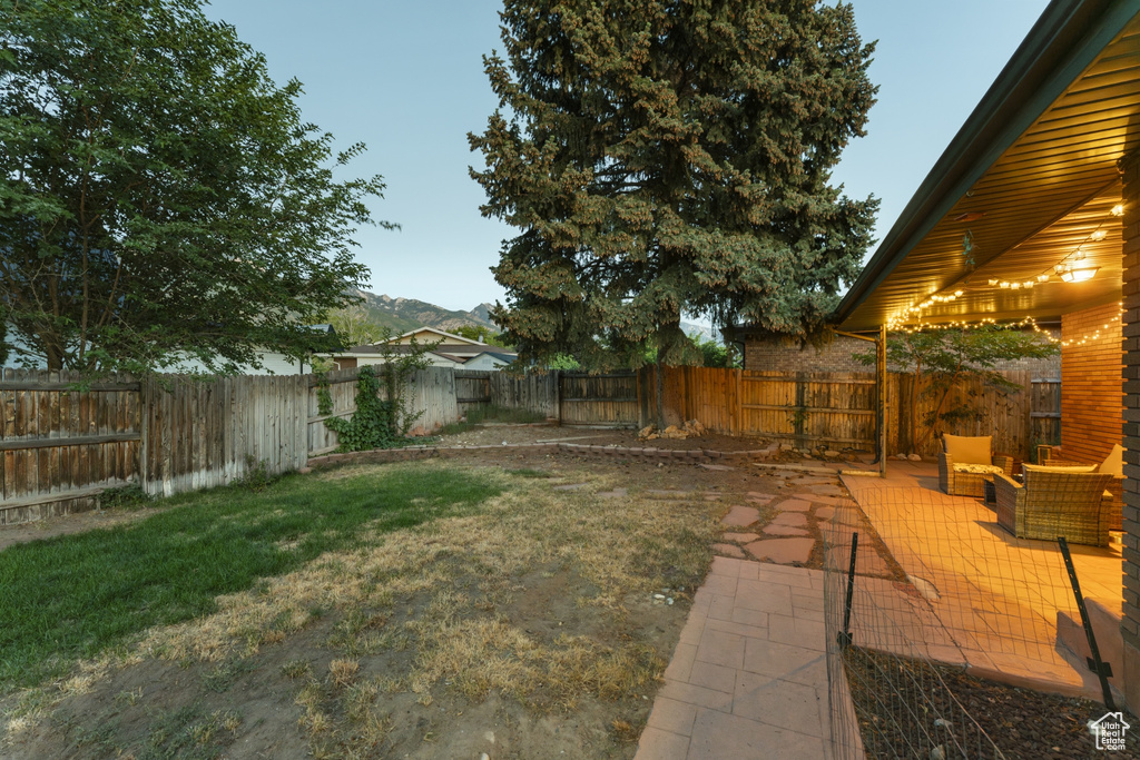 Fenced backyard with a patio and a mountain view