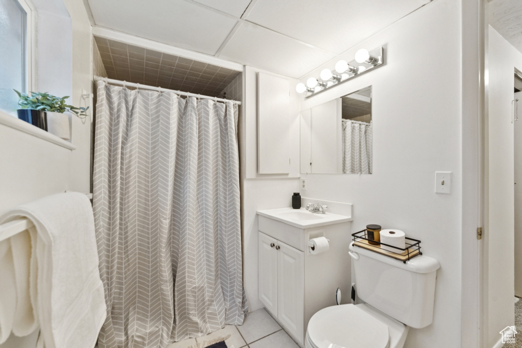 Bathroom featuring vanity, tile patterned floors, and curtained shower