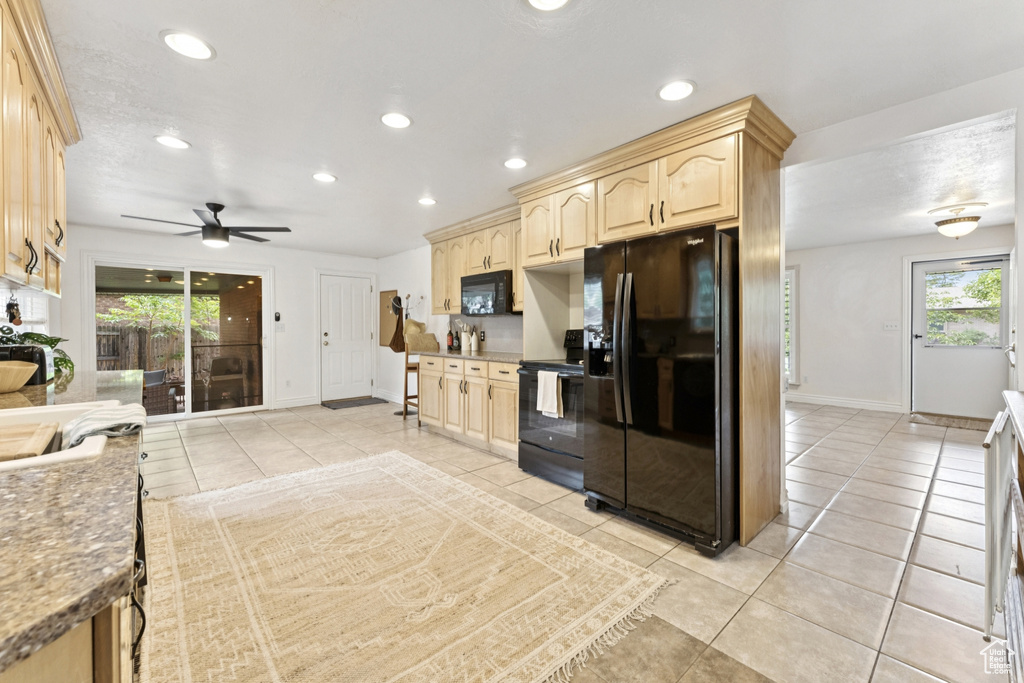 Kitchen with black appliances, light brown cabinetry, light tile patterned flooring, recessed lighting, and a ceiling fan