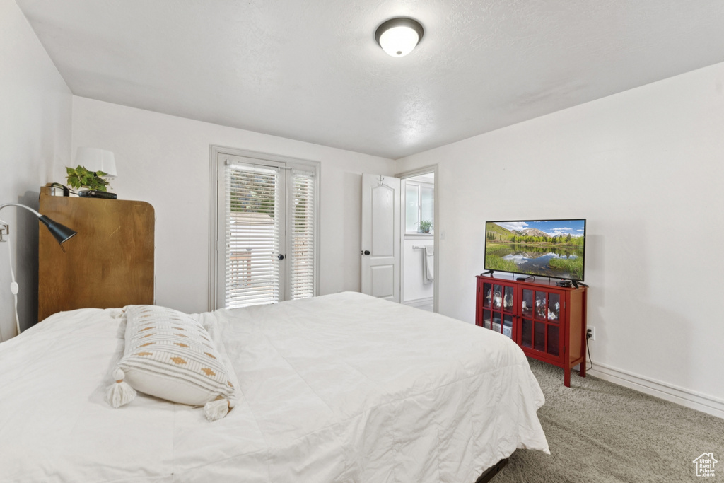 Carpeted bedroom with baseboards