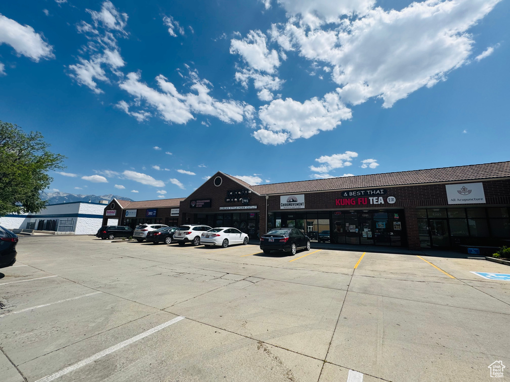 View of commercial property featuring uncovered parking