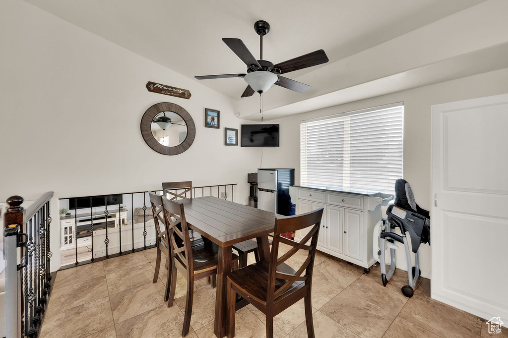 Dining room with a ceiling fan and vaulted ceiling
