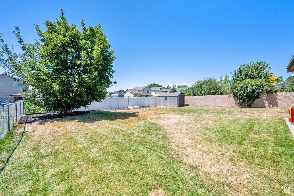 Fenced backyard with a storage unit