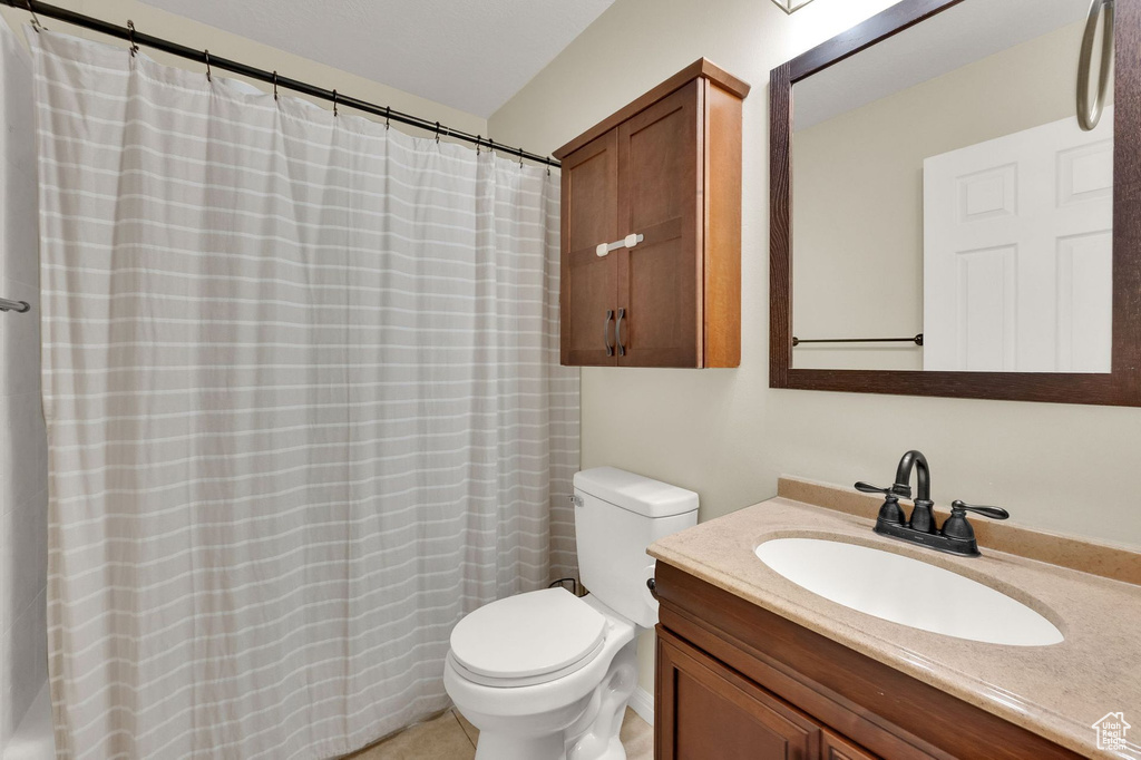Full bath with vanity, a shower with curtain, and tile patterned floors