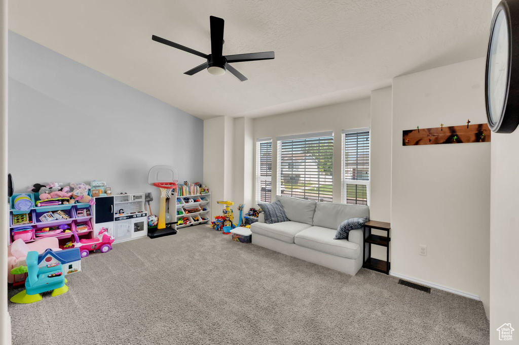 Rec room with a ceiling fan and carpet floors