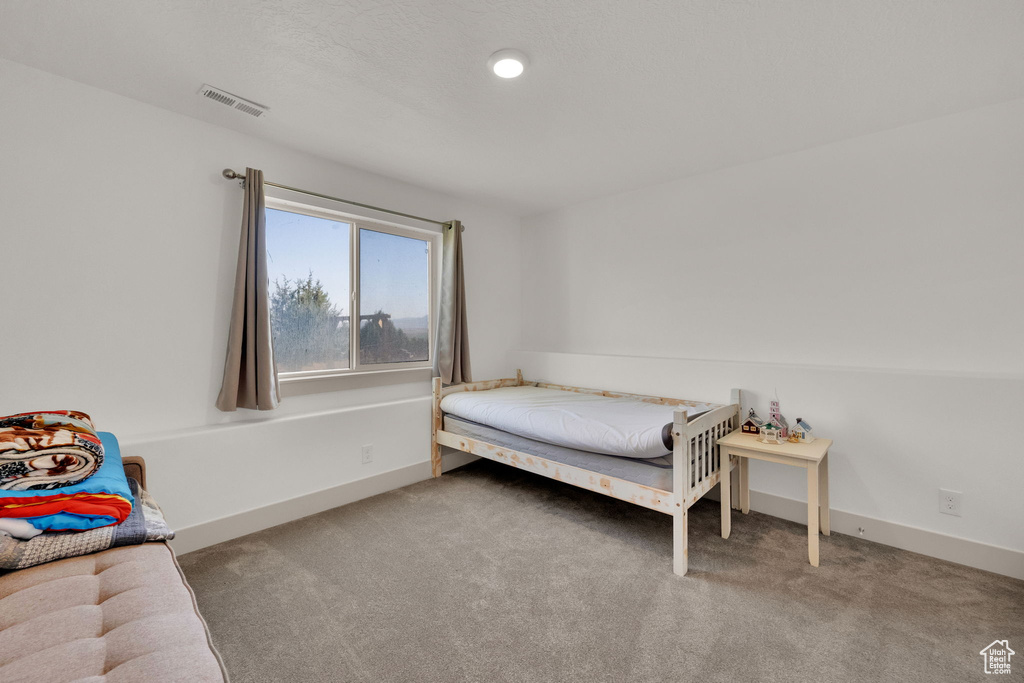 Carpeted bedroom with baseboards