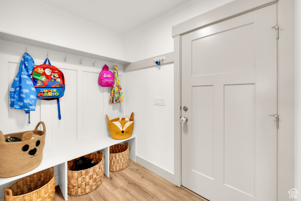 Mudroom featuring wood finished floors and baseboards