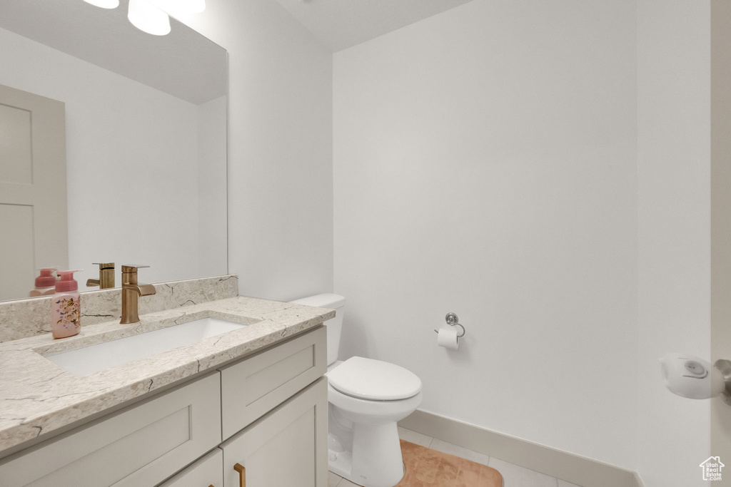 Bathroom with tile patterned floors and vanity