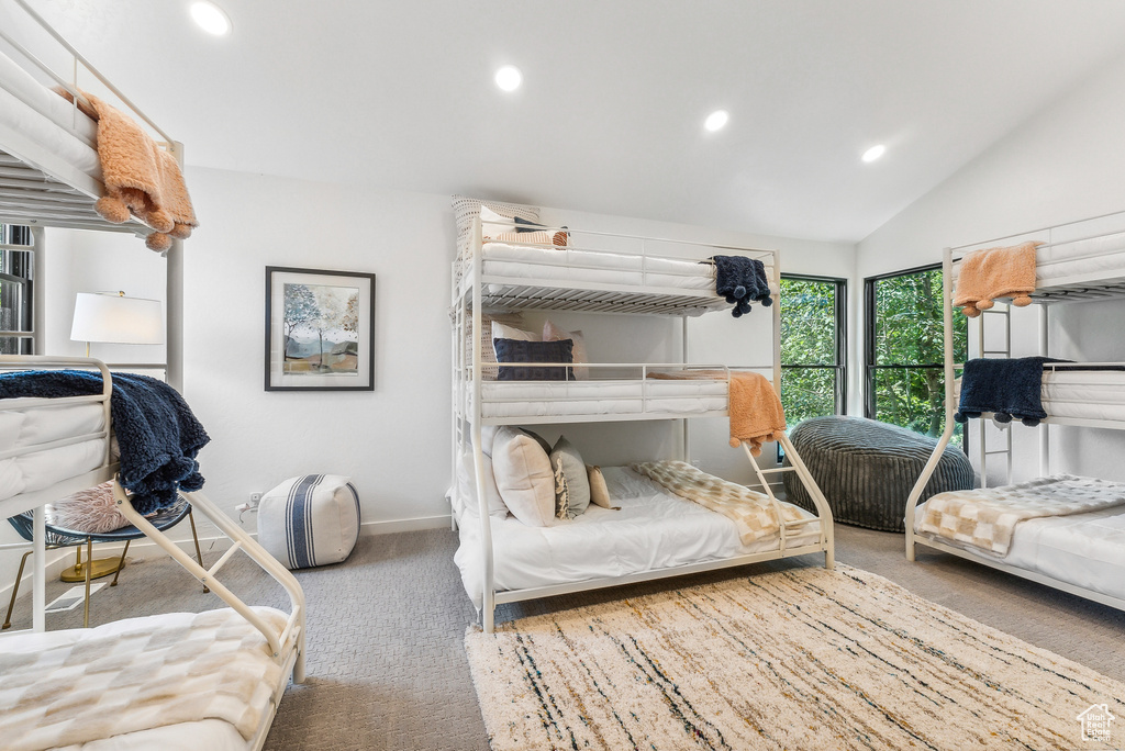 Carpeted bedroom with recessed lighting and vaulted ceiling