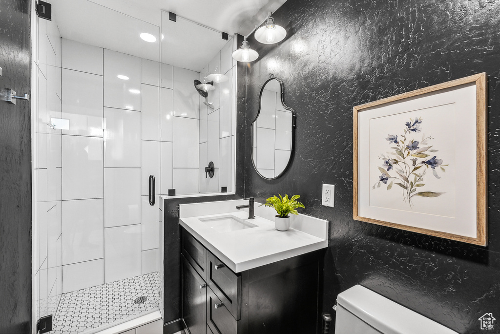 Bathroom with a shower stall and vanity