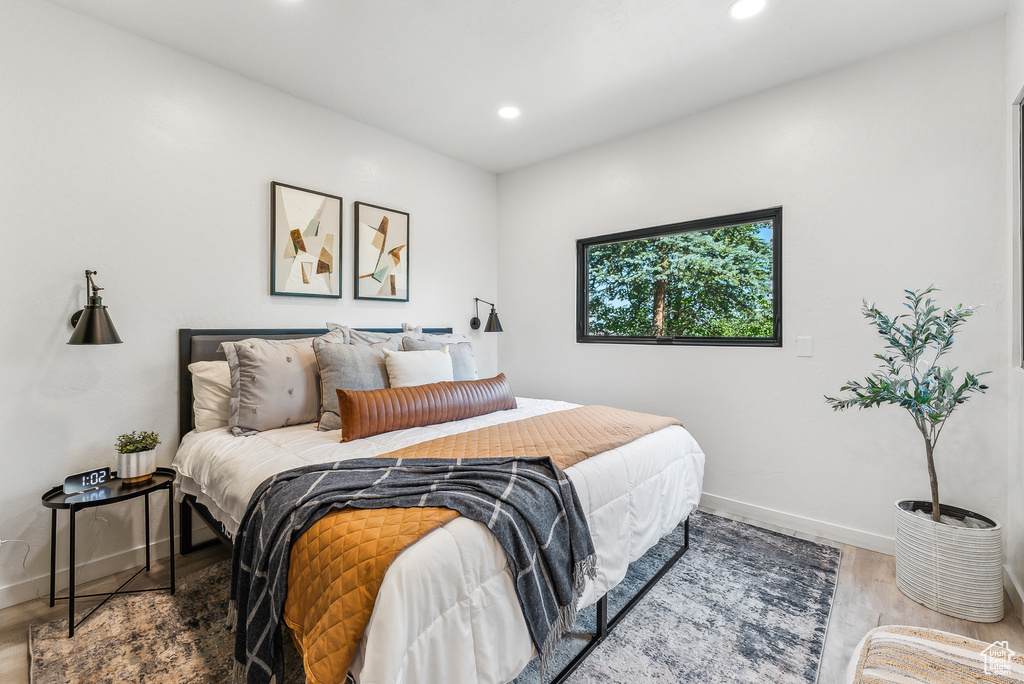 Bedroom featuring wood finished floors and recessed lighting