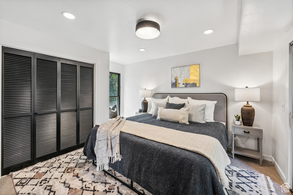 Carpeted bedroom with a closet and recessed lighting