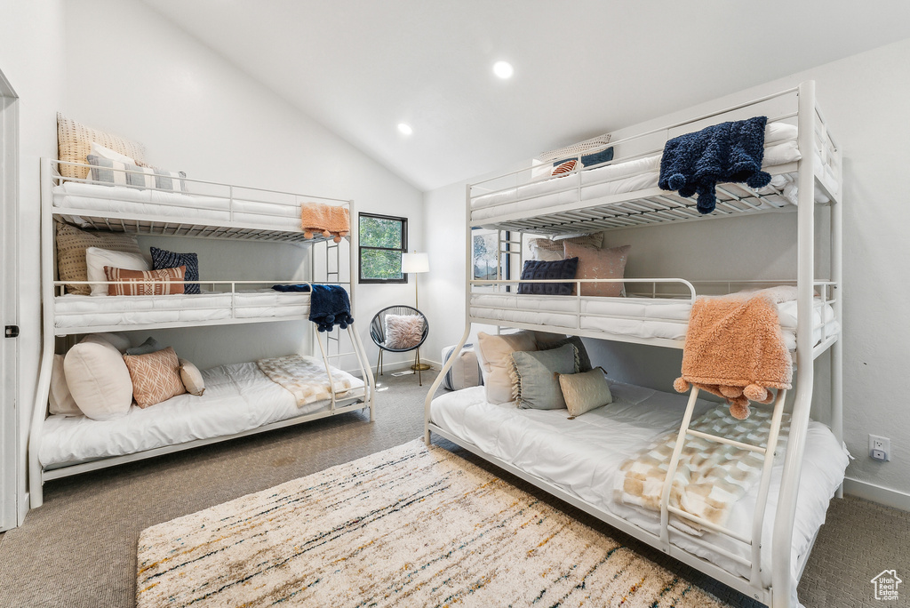 Carpeted bedroom with vaulted ceiling and recessed lighting