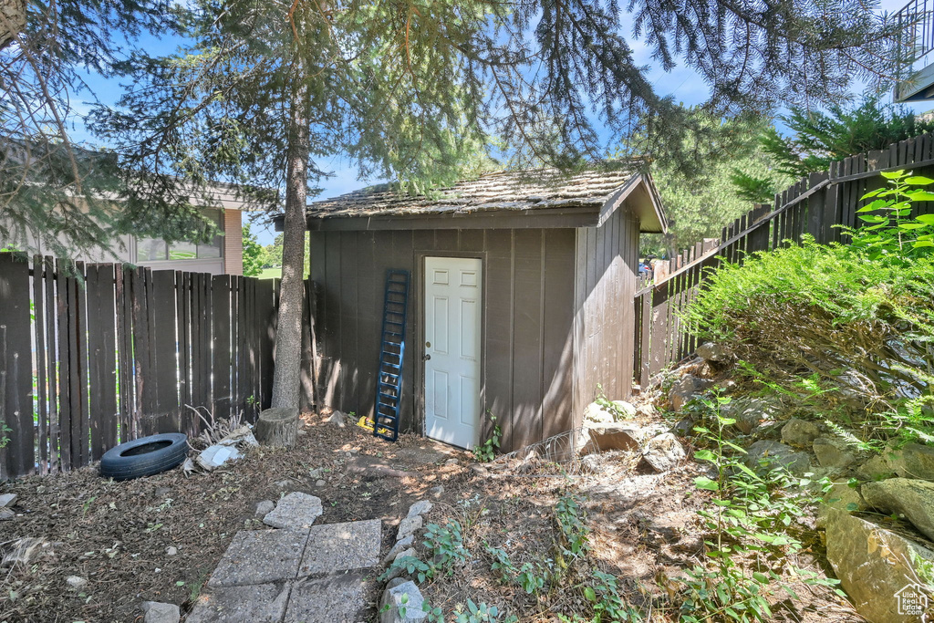 View of shed with a fenced backyard