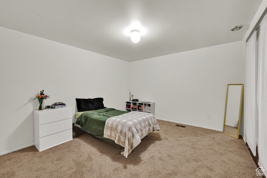 Carpeted bedroom with baseboards