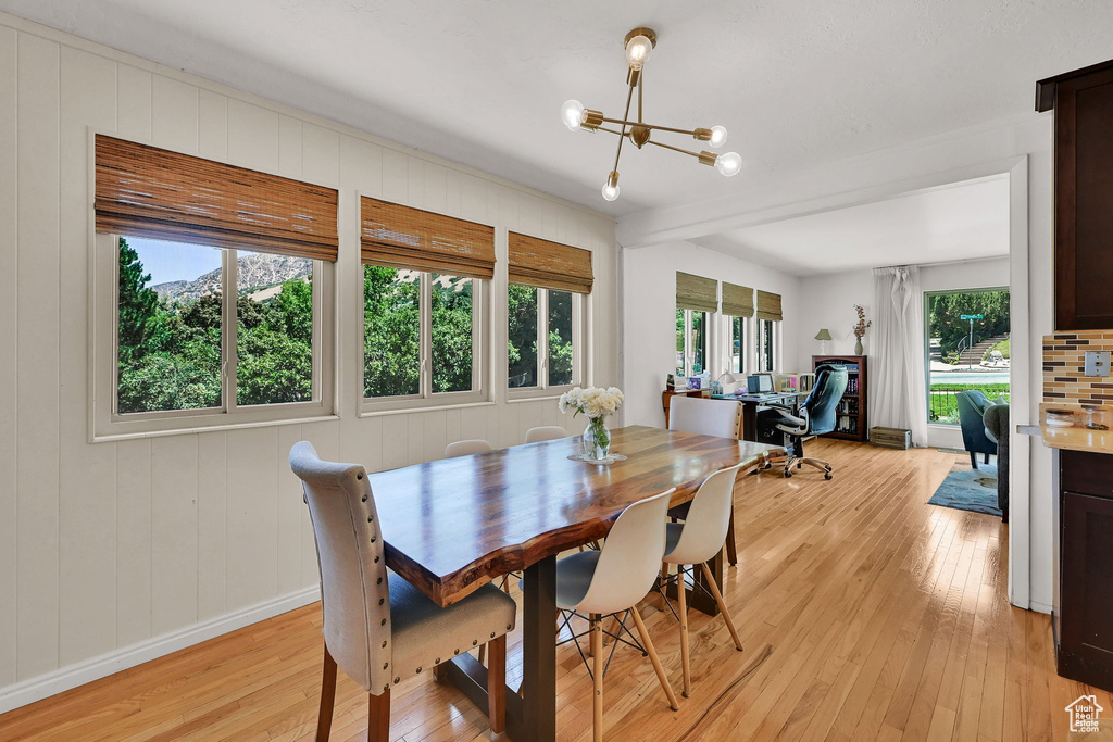 Dining room featuring light wood-type flooring, a chandelier, and an office area