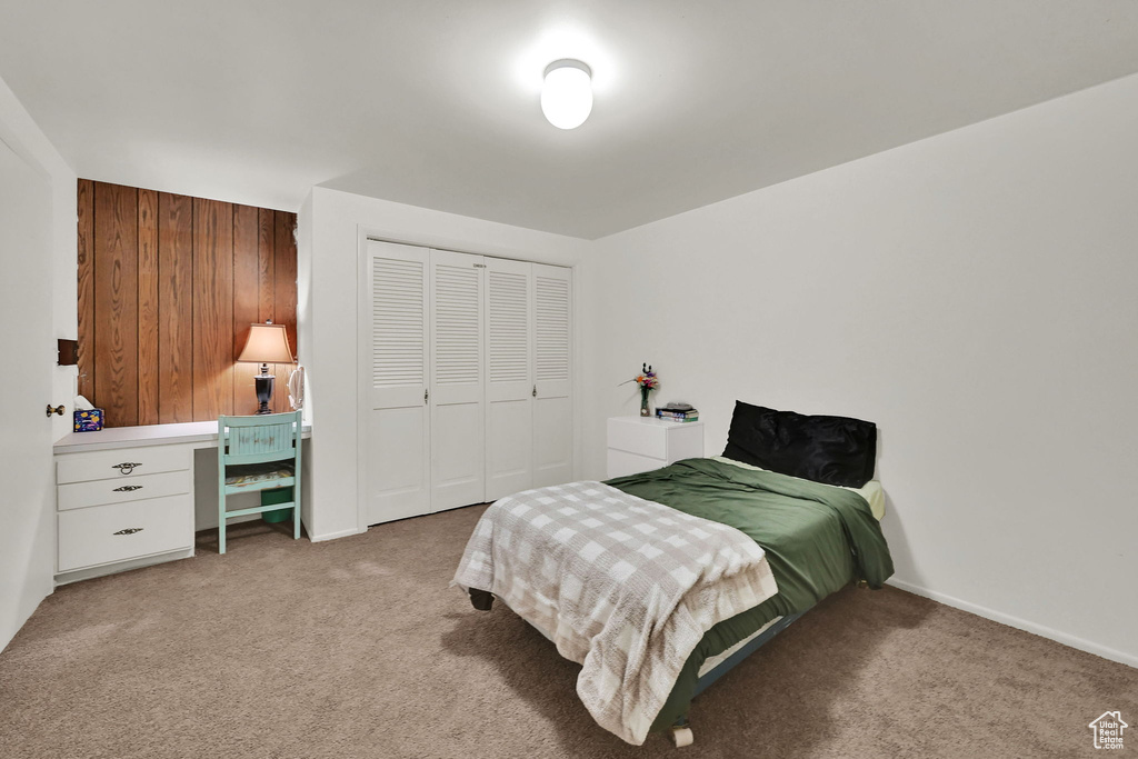 Bedroom featuring carpet flooring and a closet