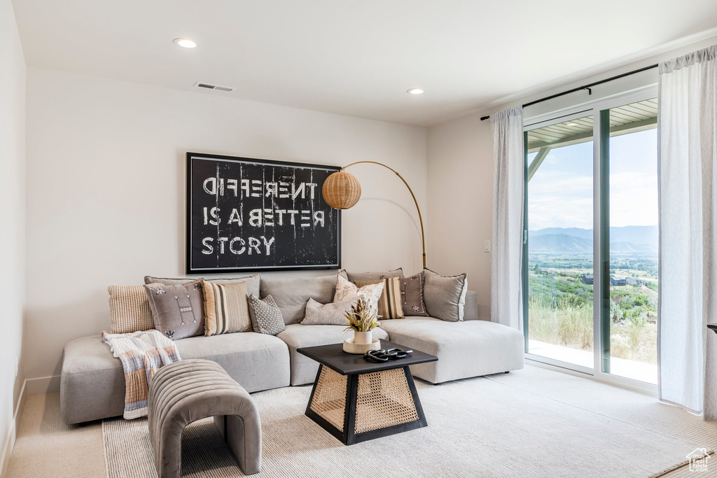 Carpeted living room featuring a mountain view and recessed lighting