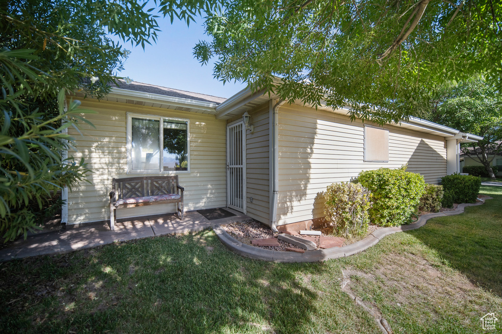 View of home's exterior with a lawn and a patio area