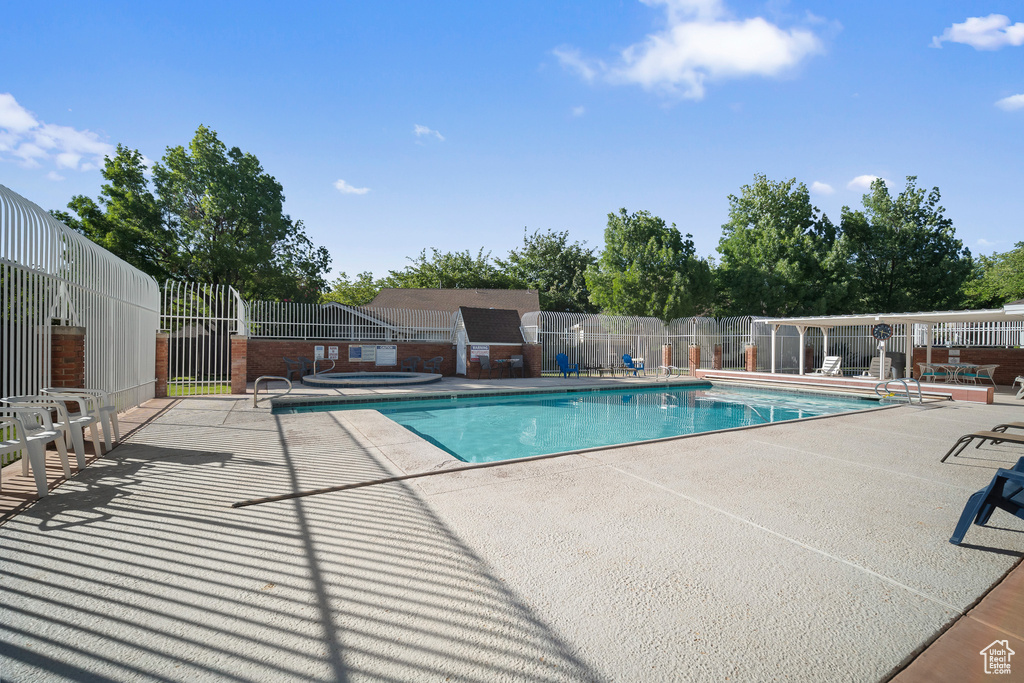 Community pool featuring a patio