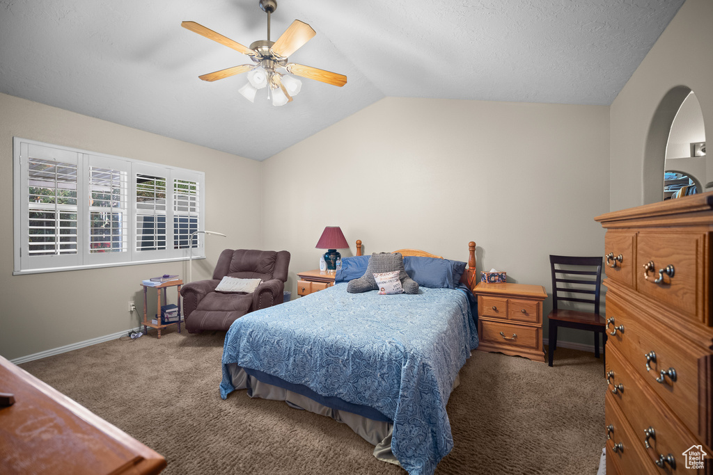 Bedroom featuring carpet, lofted ceiling, and a ceiling fan