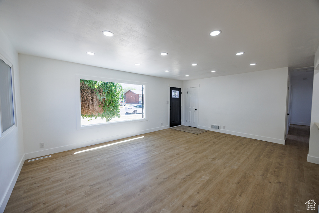 Spare room featuring recessed lighting and wood finished floors