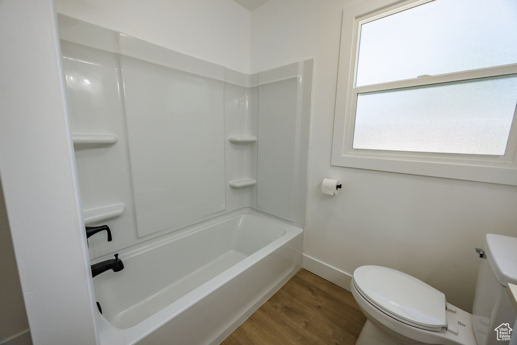 Bathroom featuring wood finished floors and bathtub / shower combination