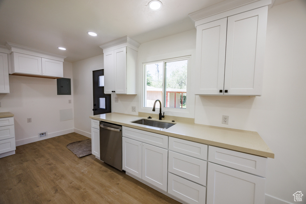 Kitchen featuring dishwasher, light wood-type flooring, white cabinets, recessed lighting, and light countertops