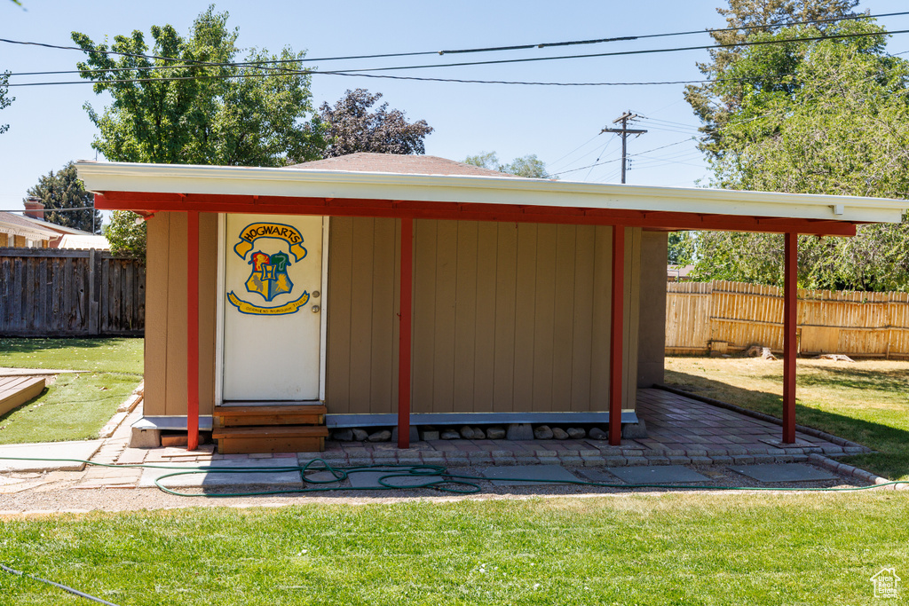 View of outdoor structure featuring a fenced backyard and entry steps