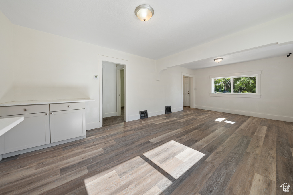 Empty room featuring wood finished floors and baseboards