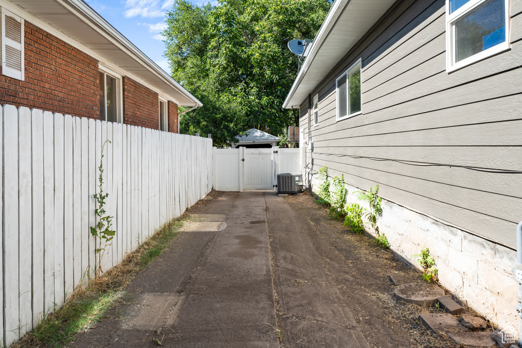 View of property exterior featuring a gate and brick siding