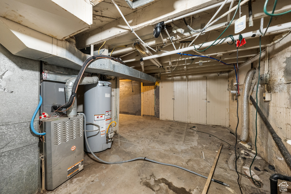 Unfinished below grade area with gas water heater and heating unit
