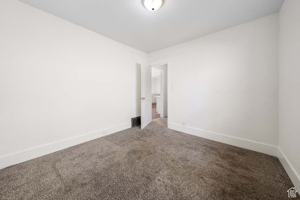 Empty room featuring light carpet