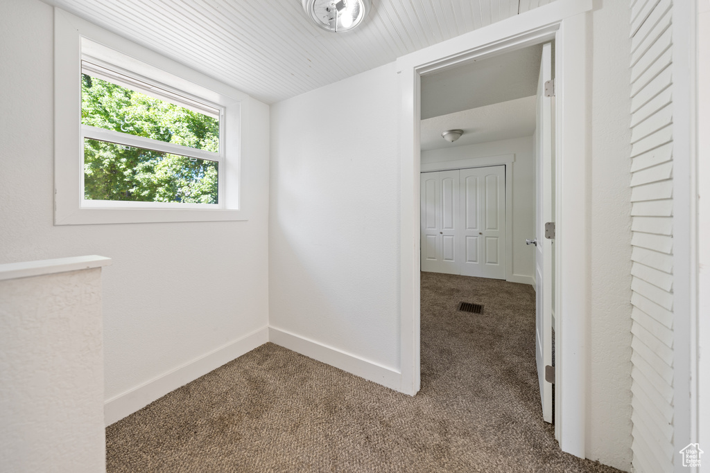 Unfurnished room with carpet flooring and baseboards