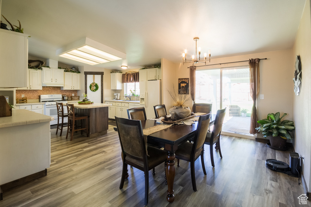 Dining space with a chandelier and wood finished floors