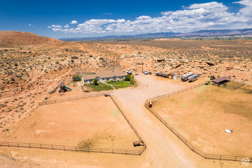 View of rural area with a desert landscape and a mountainous background