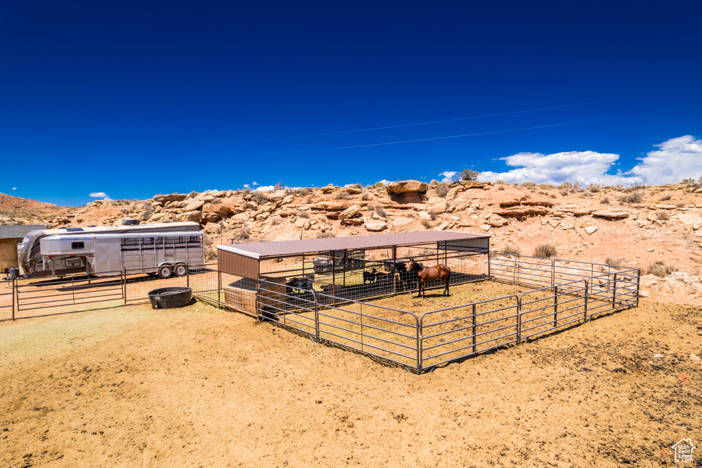 View of yard with an exterior structure, an outdoor structure, a view of countryside, and a mountain view