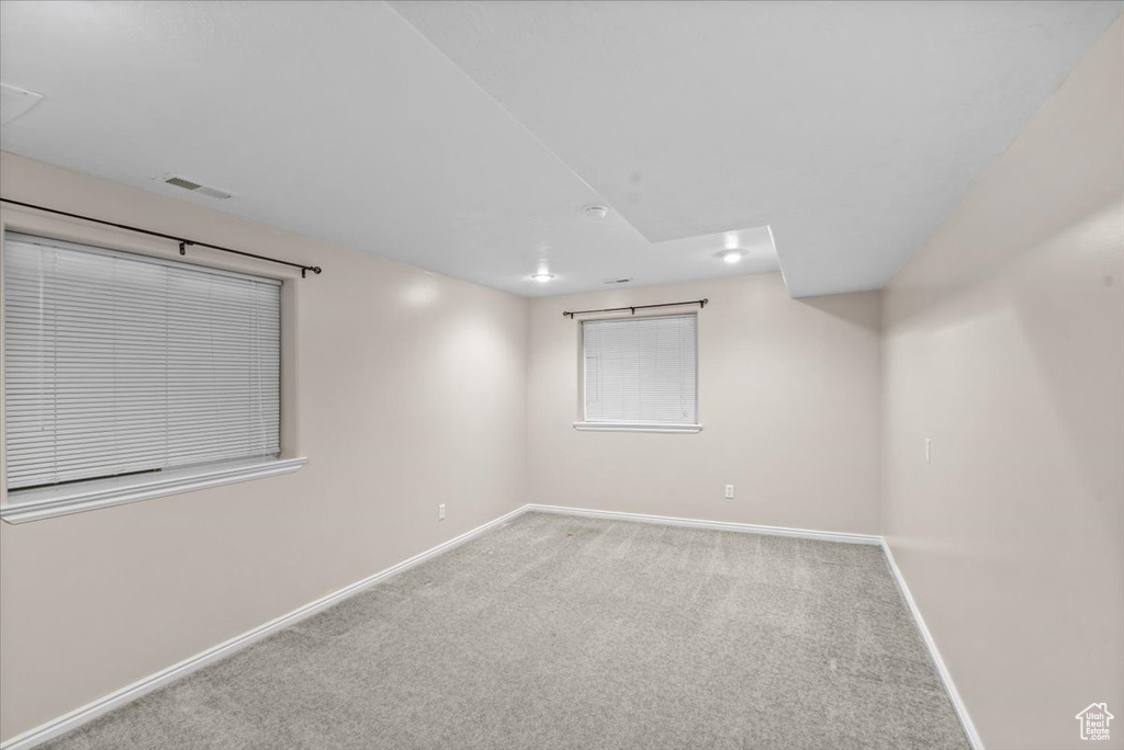 Carpeted empty room with baseboards