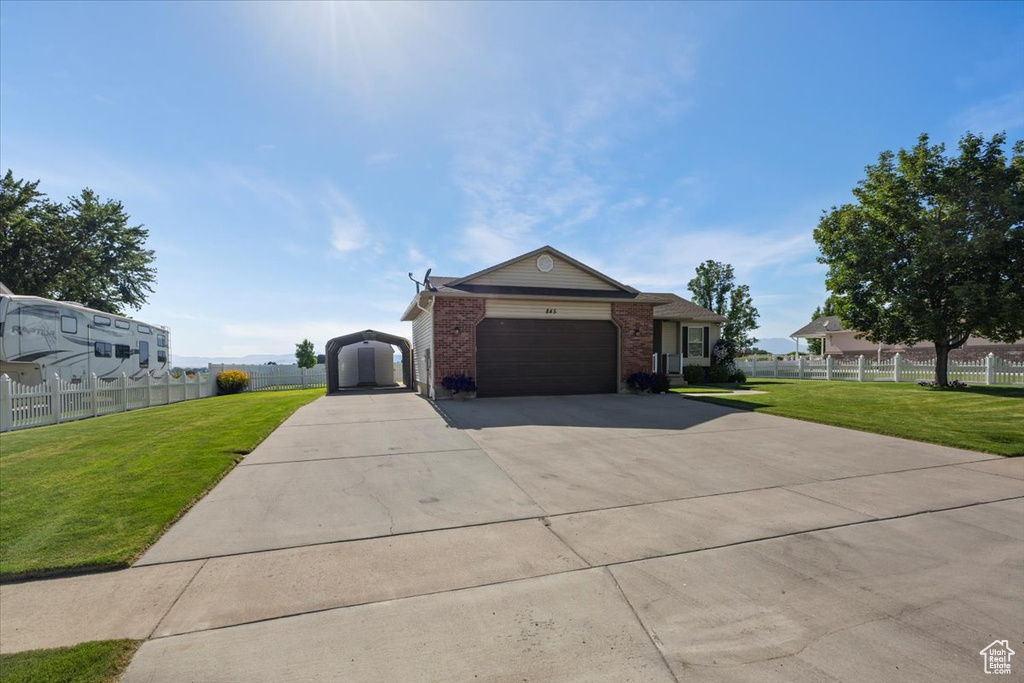 Ranch-style home featuring brick siding, concrete driveway, and a garage