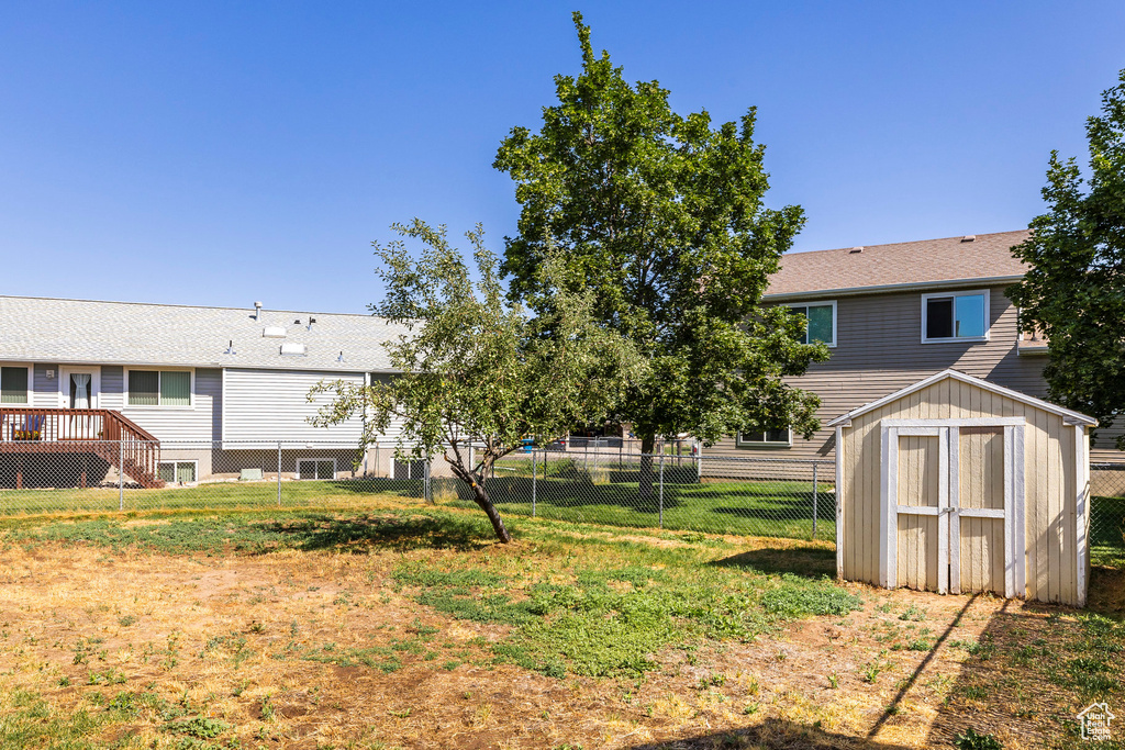Fenced backyard with a storage shed