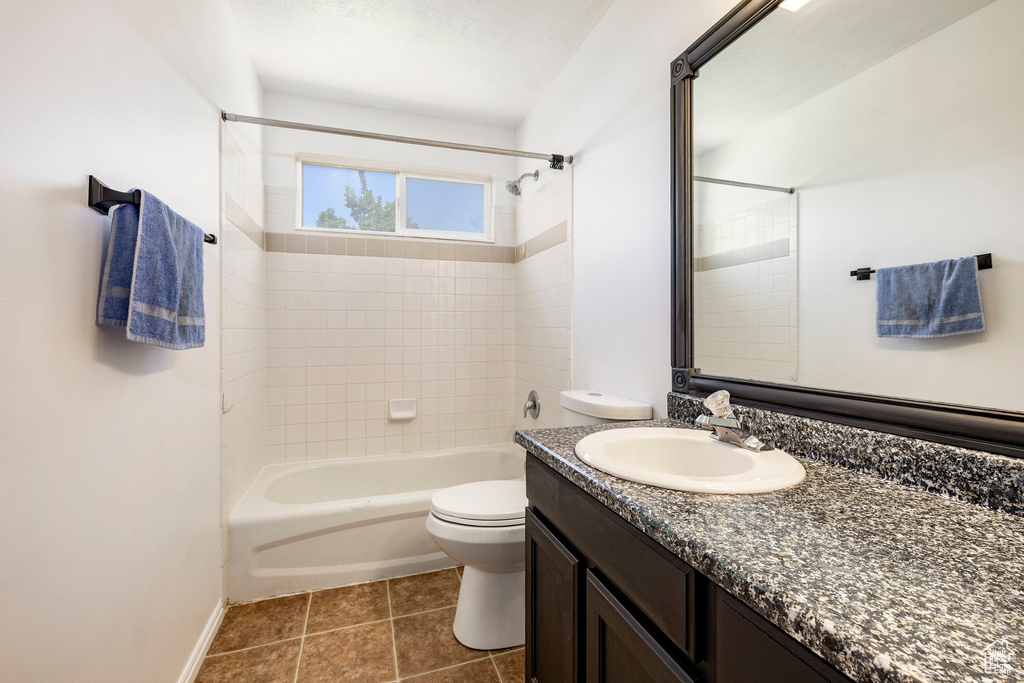 Full bath with shower / tub combination, vanity, and tile patterned floors