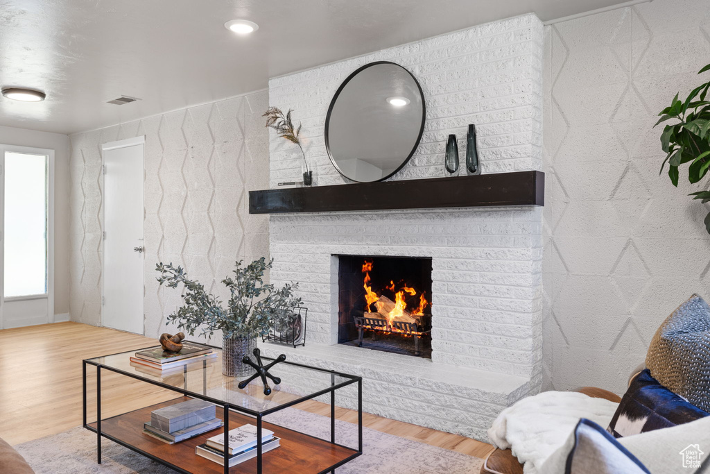 Living room with wood finished floors and a fireplace