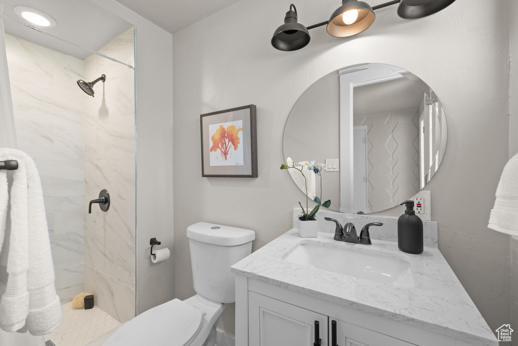 Bathroom with vanity and tiled shower